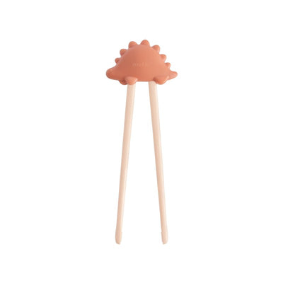 Mushie Training Chopsticks in rose color, featuring a playful dinosaur-shaped top for children learning to use chopsticks.