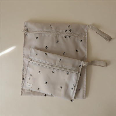 Water-resistant wet bags in two sizes featuring a bee print, designed for storing wet or dirty items.