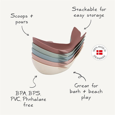 Mushie Whale Bath Stackers in pastel colors, designed for scooping and pouring; stackable for easy storage. 100% made in Denmark, BPA-free.