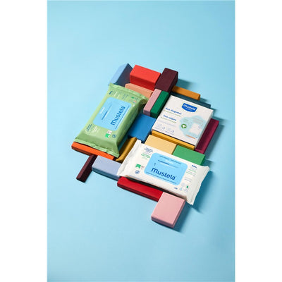 Mustela Compostable Cleansing Water Wipes, fragrance-free, displayed among colorful blocks on a light blue background.