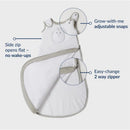 Soft pink Nested Bean Zen Sack Classic for infants, featuring adjustable snaps and a two-way zipper for easy changes.