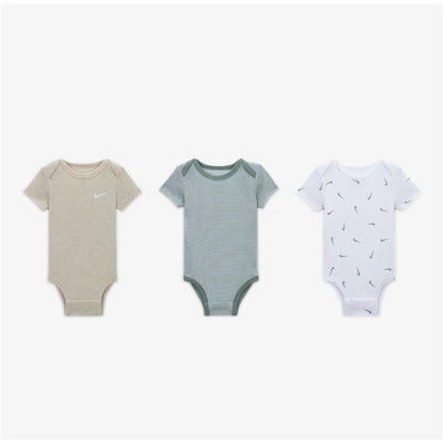 Unisex Nike baby bodysuits set, featuring three designs: plain beige with logo, striped green, and white with small logos.