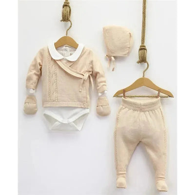 Pink knitted baby set from Nipperland including a long-sleeve top, pants, and bonnet, featuring soft textures and cozy design.