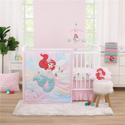 NoJo 3Pk Disney Ariel Watercolor Wishes Crib Bedding Set with pink mermaid-themed blanket and accessories in a nursery setting.