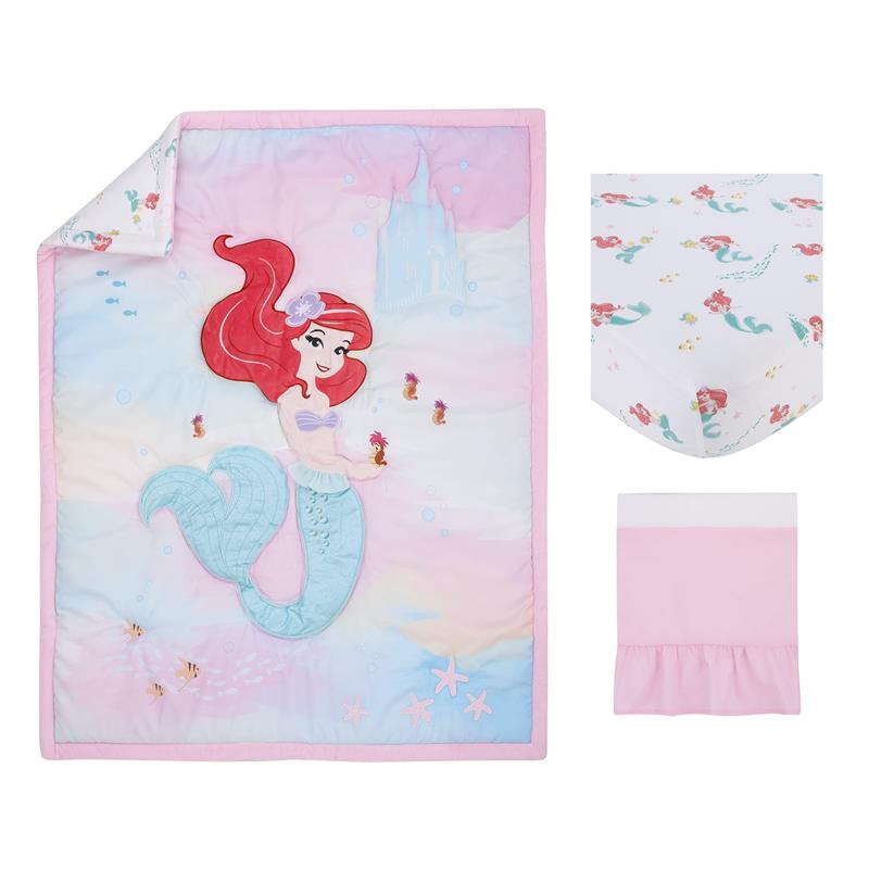 Disney Ariel-themed crib bedding set featuring a quilt with a mermaid design, a patterned crib sheet, and a pink bed skirt.