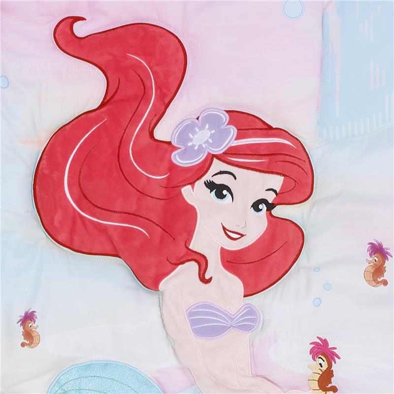 Disney Ariel design featuring a smiling mermaid with red hair, purple seashell top, and whimsical underwater motifs on crib bedding.