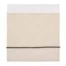 Taupe crib bedding set featuring a white top section and a decorative dark pom-pom trim at the bottom.