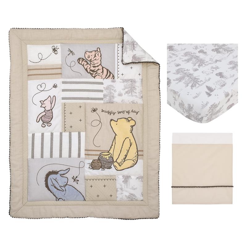 Taupe crib bedding set featuring a quilt with Winnie the Pooh, Piglet, and Eeyore designs, plus coordinating sheets.