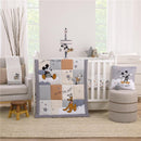Disney Mickey Mouse nursery crib bedding set featuring a quilt with Mickey, Donald, and Pluto, accompanied by decorative accessories.