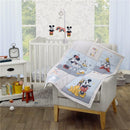 NoJo 3Pk Disney Mini Crib Bedding Set featuring Mickey, Minnie, Donald, and Pluto designs, displayed on a chair with a crib in the background.