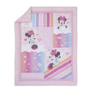 Minnie Mouse themed crib bedding set featuring colorful patches with hearts and playful designs in pink and pastel tones.