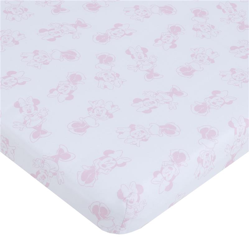 Mini crib bedding set featuring a pink and white Minnie Mouse pattern. Soft fabric with playful illustrations.