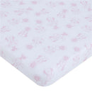 Mini crib bedding set featuring a pink and white Minnie Mouse pattern. Soft fabric with playful illustrations.