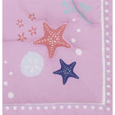 Nursery bedding set featuring a pink design with colorful starfish, sea flowers, and decorative dots.
