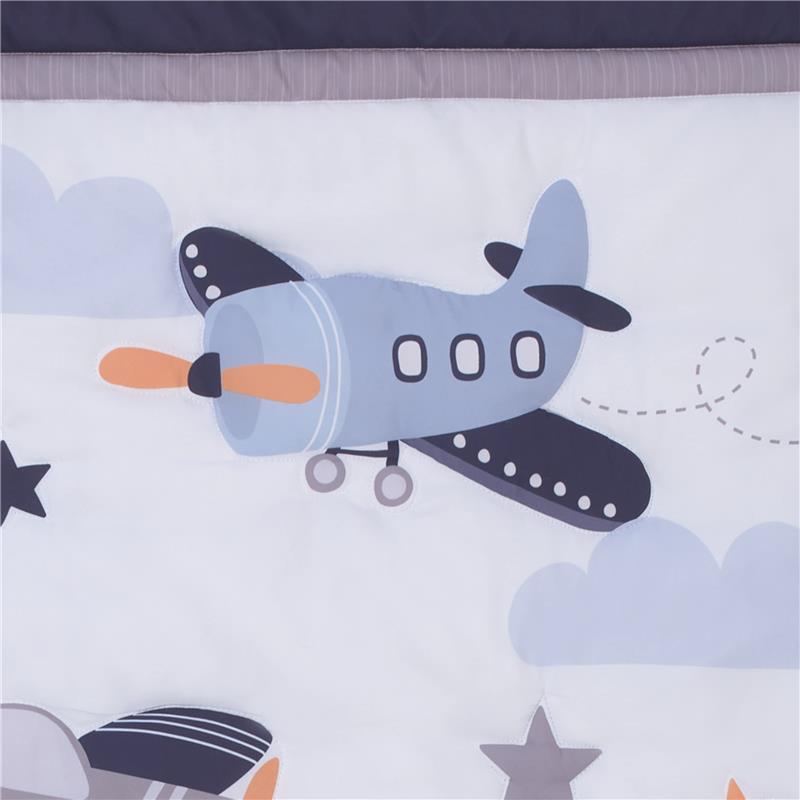 Bedding set featuring a whimsical blue airplane design with clouds and stars, ideal for nursery decor.
