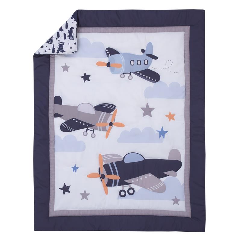 Mini crib bedding set featuring colorful airplanes, clouds, and stars on a white background with a navy border.
