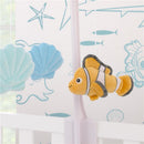 Plush Nemo toy with seashells hanging from a mobile, designed for nursery decor.