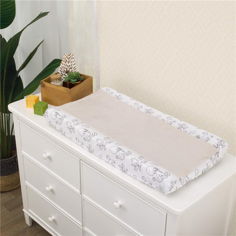 Super soft changing pad cover featuring Lion King characters, displayed on a white dresser with decorative items.