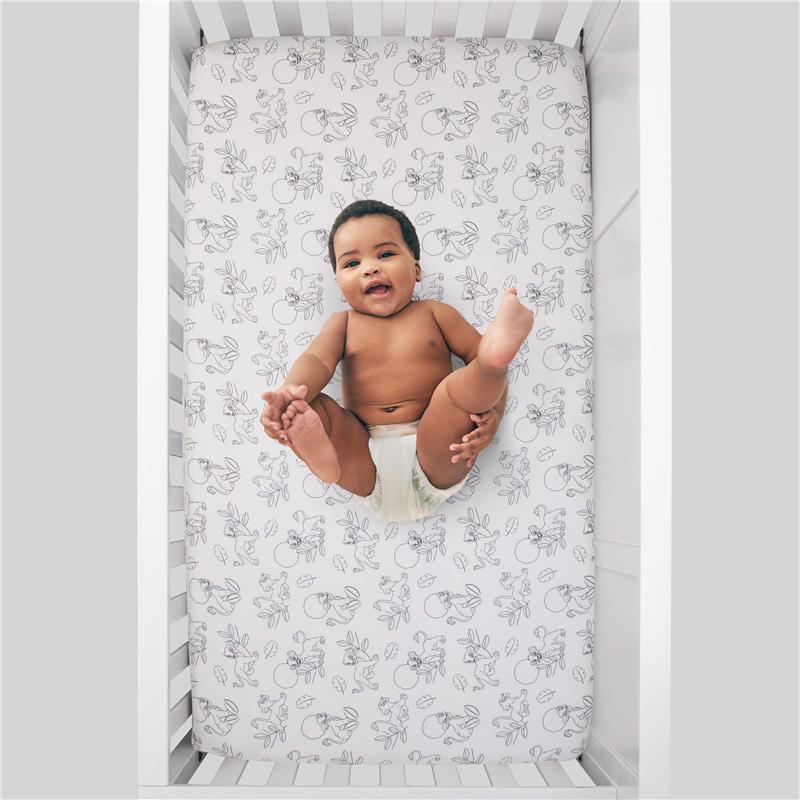 Super soft fitted crib sheet featuring Disney Lion King characters, with a baby lying happily in a crib.