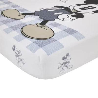 Fitted crib sheet featuring Mickey Mouse on a plaid design, designed for a nursery, made of 100% cotton.