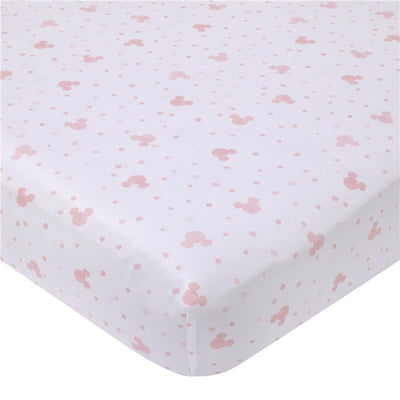 Fitted crib sheet featuring a white background with pink Minnie Mouse icons and polka dots, designed for a nursery.