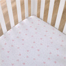 Fitted crib sheet featuring a polka dot design with Minnie Mouse icons in soft pink and white.