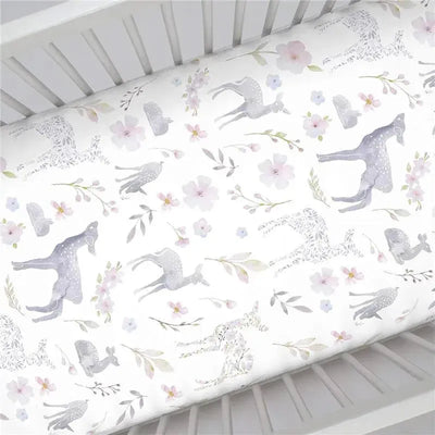 Fitted crib sheet featuring a floral deer print in soft pastel colors on a white background.