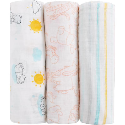 Three printed muslin swaddles featuring Winnie the Pooh designs, including characters and colorful patterns.