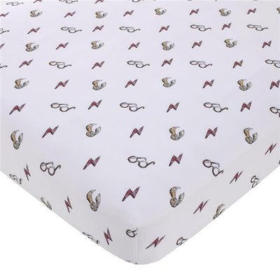 Crib sheet featuring a white background with repeating patterns of Harry Potter glasses, lightning bolts, and golden snitches.