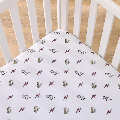 Crib sheet featuring Harry Potter-themed design with lightning bolts and glasses illustrations.