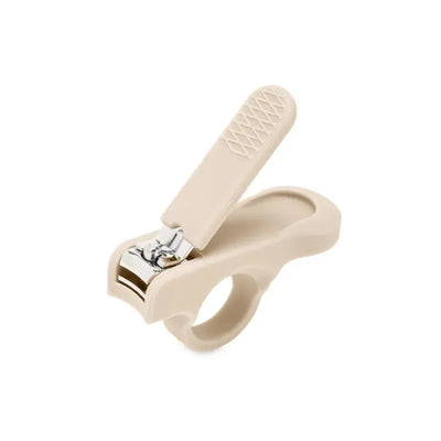 Baby nail clipper in a soft beige color with a curved handle and a silver cutting edge.