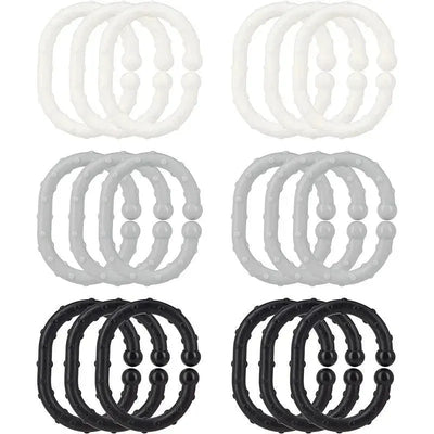 Eighteen Nuby Linkables teething toys in black, gray, and white, featuring textured rings for infants to chew on.