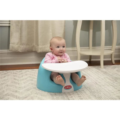 Nuby Dr Talbots tray and foam booster seat with a smiling baby sitting inside, wearing a pink shirt.