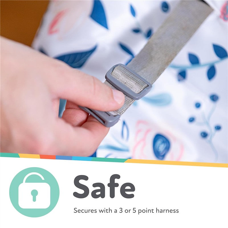 Water-resistant high chair cover in floral print, showing a hand adjusting a gray strap with safety text below.