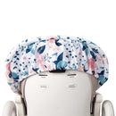 Water-resistant high chair cover featuring a floral print in pink, blue, and green, designed for easy cleaning and stylish protection.