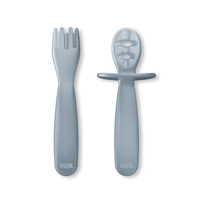 Two grey utensils from the Nuk For Nature Pretensil 2Pk Set: a fork with three prongs and a spoon with a handle.