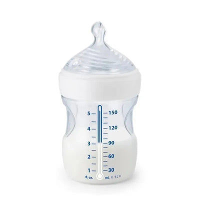 Nuk Simply Natural baby bottle, clear with a white cap, marked with measurement increments for feeding.