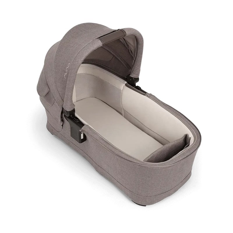 Nuna Bassinet in Umber color, featuring a soft interior and a foldable canopy for newborns.
