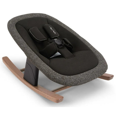 Nuna BRYN Newborn Rocker in black and grey fabric with wood rocking base and safety harness. Ideal for soothing infants.