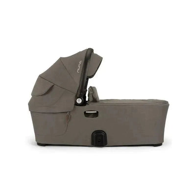 Nuna DEMI™ next Bassinet in Hazelwood color, featuring a sleek design with a removable canopy and adjustable reclining position.