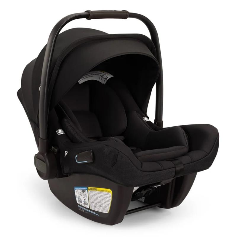 Nuna Pipa Aire Rx Infant Car Seat in Caviar/Chocolate, featuring a secure harness, removable canopy, and safety instruction label.