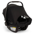 Nuna Pipa Aire Rx Infant Car Seat in Caviar/Chocolate with a black canopy and safety warning labels on the base.