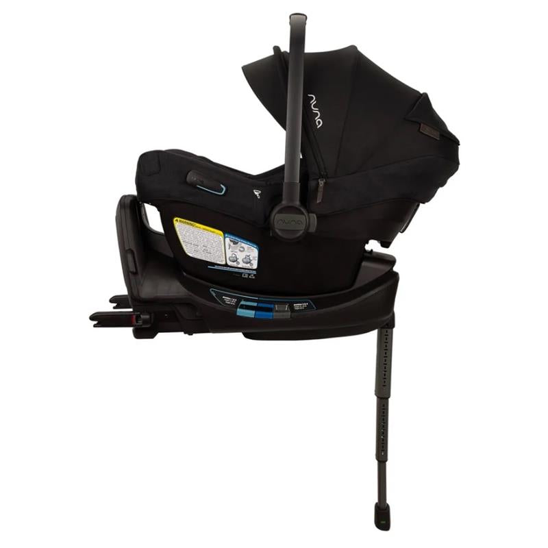 Nuna Pipa Aire Rx Infant Car Seat in Caviar/Chocolate, featuring a canopy, safety labels, and adjustable base support.