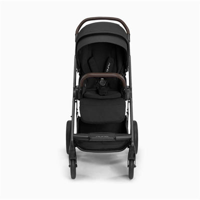 Nuna Pipa Urbn + Mixx Next Travel System in Caviar/Chocolate, featuring a sleek design with brown handlebars and a comfortable seat.