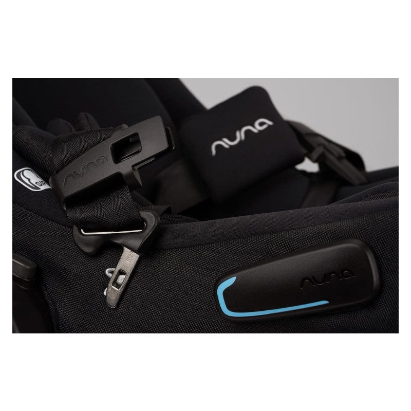 Detail of Nuna Swiv + Pipa Aire Rx travel system in Caviar/Chocolate, showing black harness and adjustable buckle.
