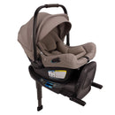 Nuna Swiv + Pipa Aire Rx travel system in Cedar color, featuring a car seat with a soft, neutral fabric and safety labels visible.