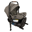Nuna Swiv + Pipa Aire Rx Travel System in Granite, featuring a car seat with a grey fabric cover and safety labels.