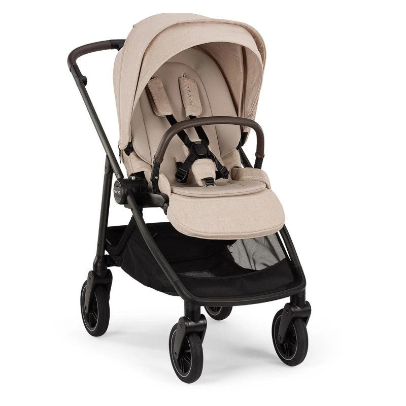 Nuna Swiv stroller in Biscotti color with a beige seat and adjustable canopy, featuring a spacious undercarriage.