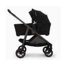 Nuna Swiv stroller with attached bassinet in Caviar - Chocolate color, featuring a sleek design and sturdy wheels.