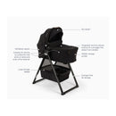 Nuna Swiv stroller bundle in Caviar color with a bassinet on a stand, featuring storage basket and ventilation panels.